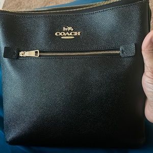 A black leather  shoulder Coach bag,